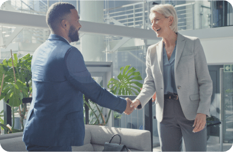 Two professionals shaking hands in an office